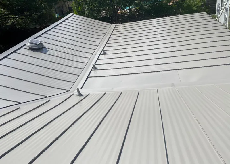 Solar attic fan installed on a metal roof for Roof Ventilation in Whiskey Creek